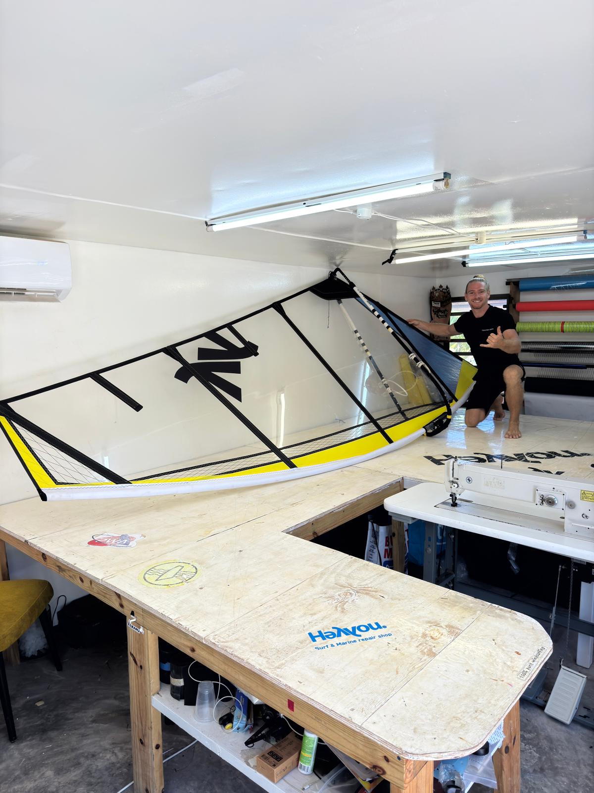 Close-up of a handmade HeYYou sail: carbon scrim, monofilm window and neon panels