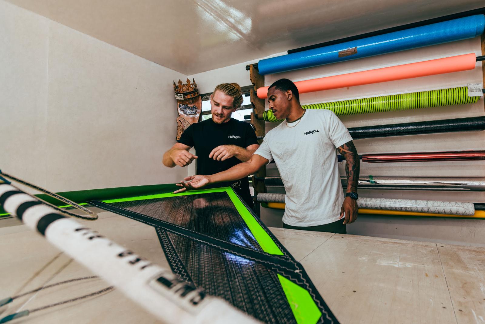 Youp and a team rider inspecting a finished HeYYou sail in the workshop